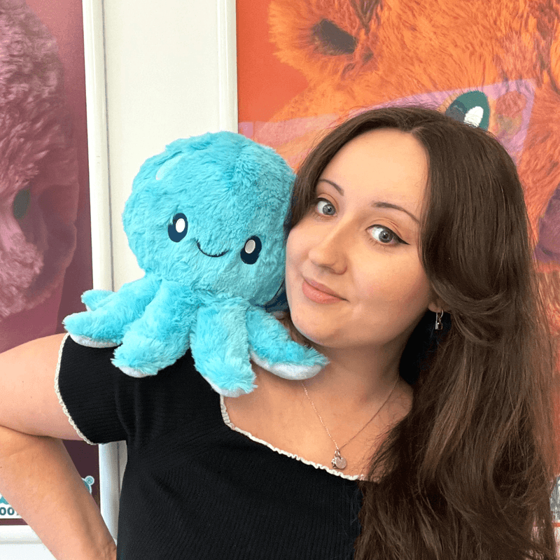 Woman holding the Mini Squishable Blue Baby Octopus plush toy