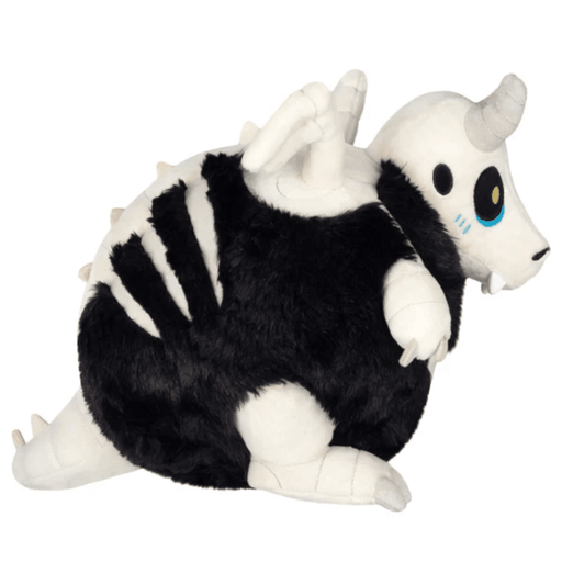Side view of Mini Squishable Bone Dragon plush showing white wings, horns and striped body