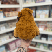 Mini Squishable Capybara plush toy held in hand, back view showing the fluffy brown body, rounded shape and small ears