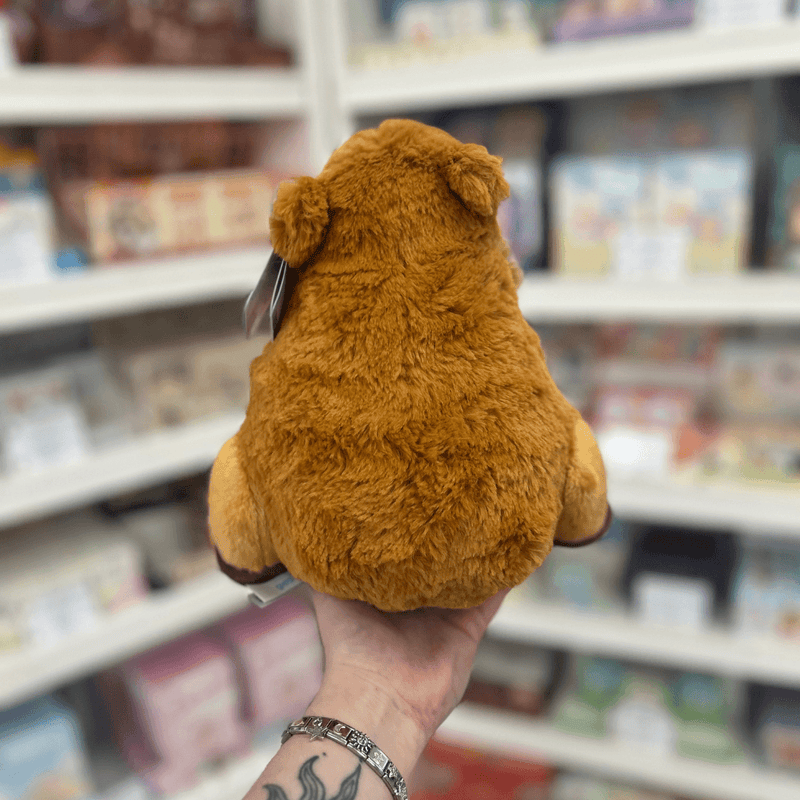 Mini Squishable Capybara plush toy held in hand, back view showing the fluffy brown body, rounded shape and small ears