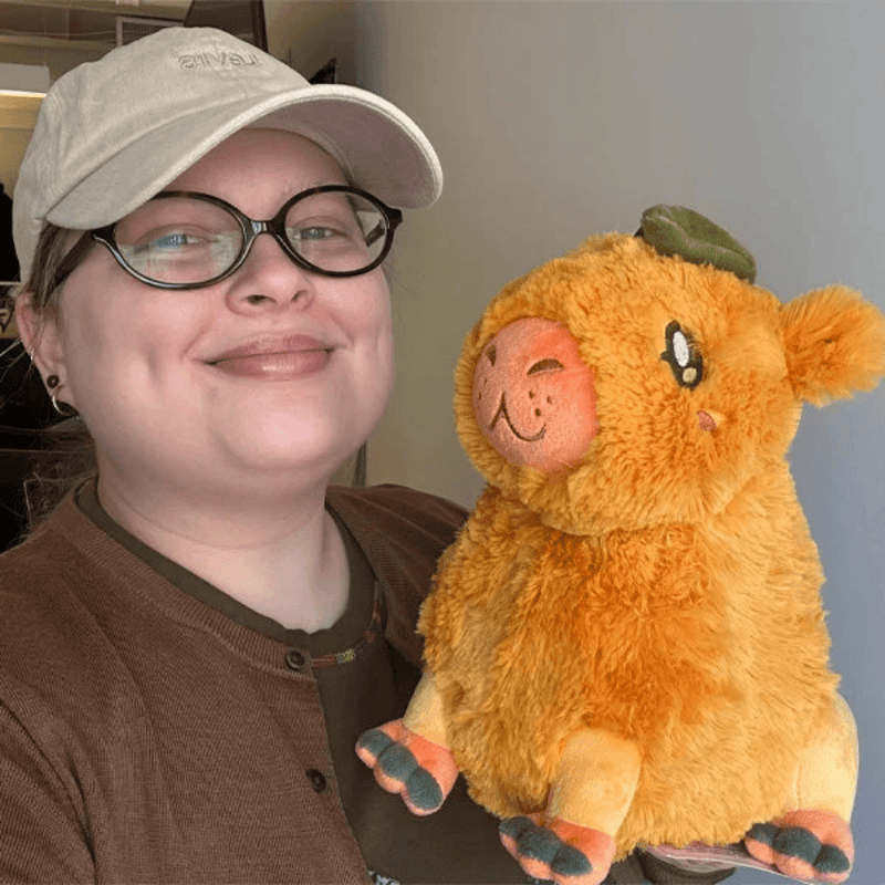 Mini Squishable Citrus Capybara plush being held