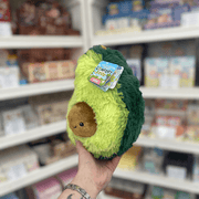 Mini Squishable Comfort Food Avocado plush toy held in hand, angled view with tag visible