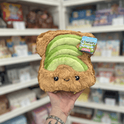 Mini Squishable Comfort Food Avocado Toast plush toy held in hand, front view with tag visible