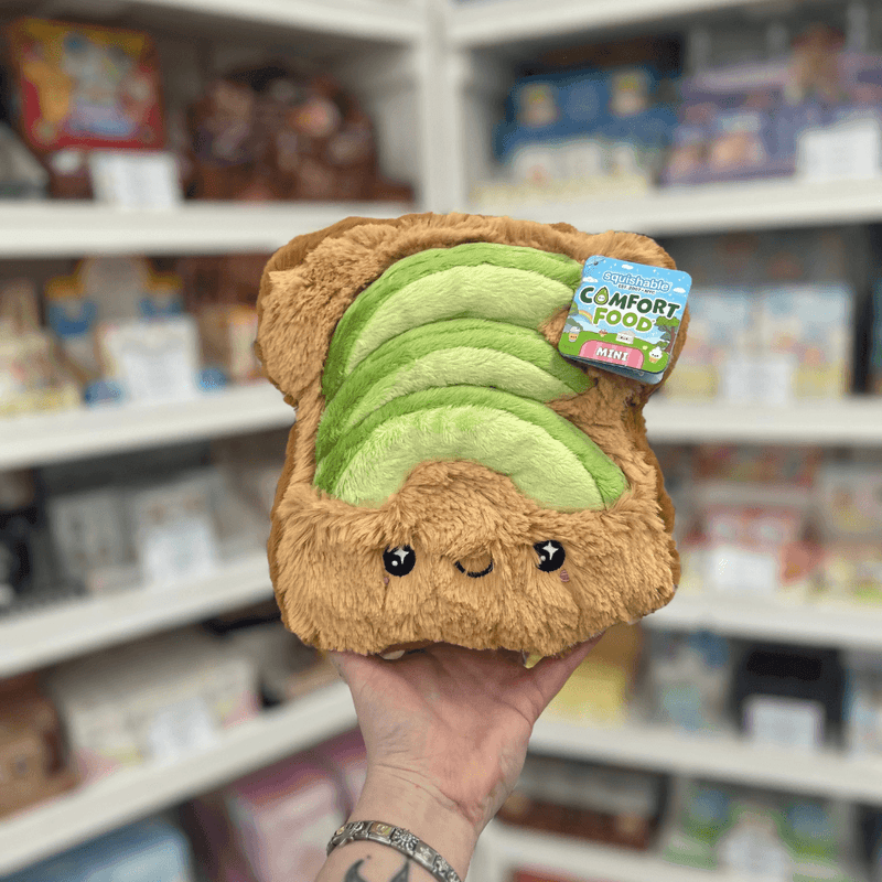 Mini Squishable Comfort Food Avocado Toast plush toy held in hand, front view with tag visible