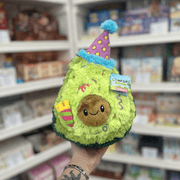 Mini Squishable Comfort Food Birthday Avocado plush toy held in hand, front view with party hat and candle