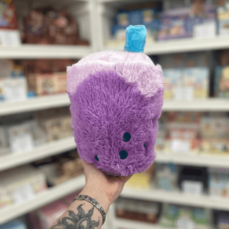 Mini Squishable Comfort Food Bubble Tea plush toy held in hand, side back view showing blue straw