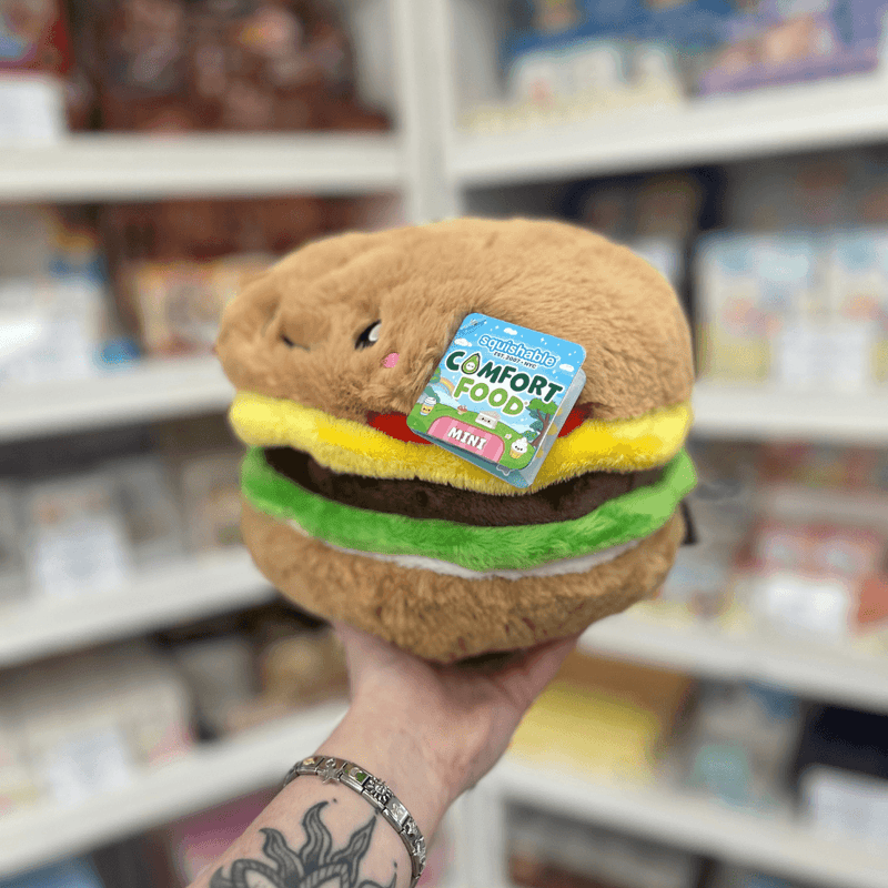 Mini Squishable Comfort Food Cheeseburger plush toy held in hand, angled view with tag visible