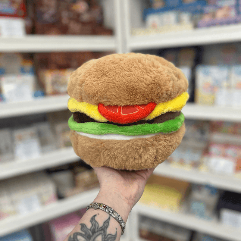Mini Squishable Comfort Food Cheeseburger plush toy held in hand, back view showing plush bun, lettuce, cheese and tomato layers