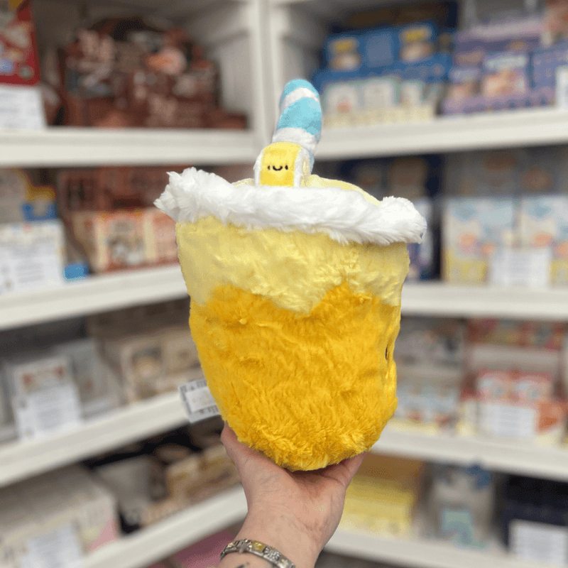 Mini Squishable Comfort Food Lemonade plush toy held in hand, back angle view showing striped straw
