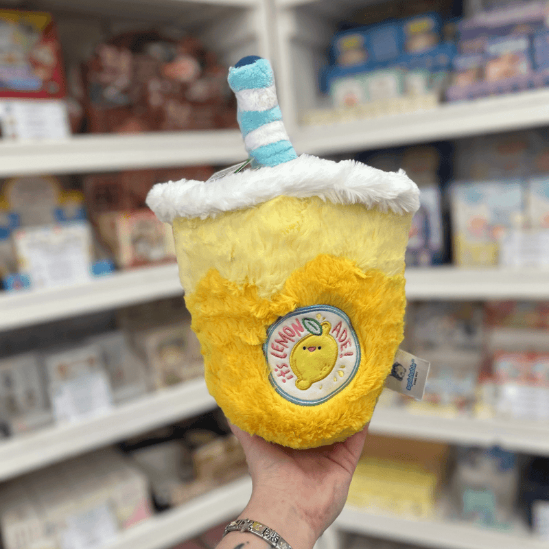 Mini Squishable Comfort Food Lemonade plush toy held in hand, back view with lemonade patch