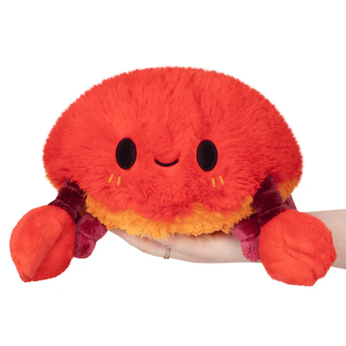 Front view of Mini Squishable Crab plush toy with smiley face