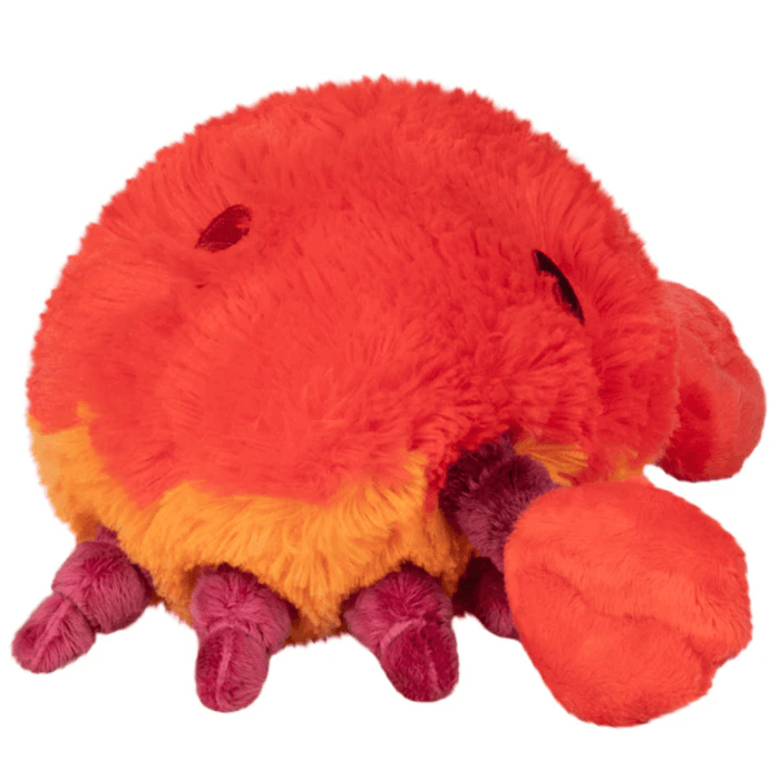 Angled side view of Mini Squishable Crab plush toy showing claws and legs