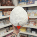 Mini Squishable Deviled Egg plush toy held in hand, back view showing white egg shape and red devil tail detail