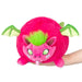 Front view of the Mini Squishable Dragon Fruit plushie featuring a vibrant pink dragon with green wings and fuzzy green hair.