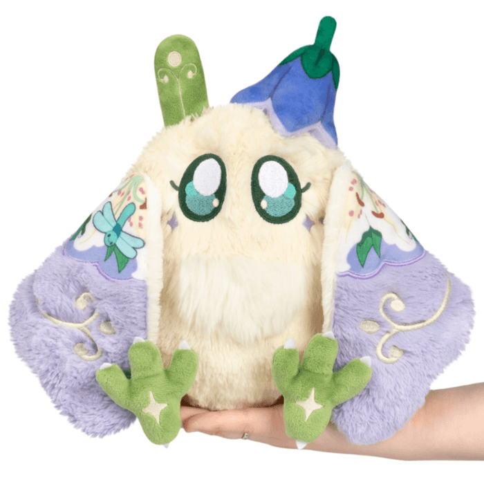 Mini Squishable Fairy Baby Mothman Plush held in hand with wings open and floral fairy details