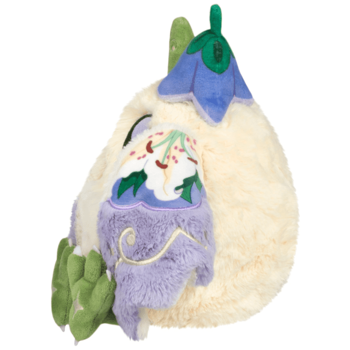 Side view of Mini Squishable Fairy Baby Mothman Plush showing blue flower hat and patterned wing