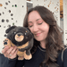 Person holding Mini Squishable Fluffy Dachshund plush toy
