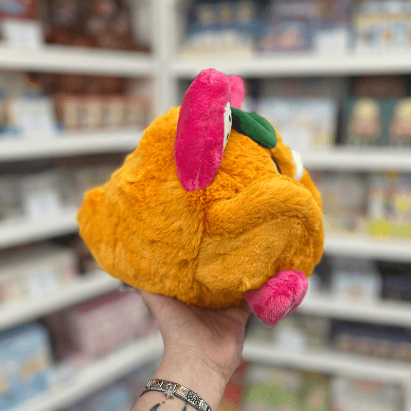 Mini Squishable Fruit Bat plush toy held in hand, back view