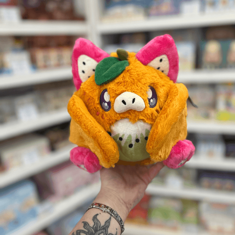 Mini Squishable Fruit Bat plush toy held in hand, front view