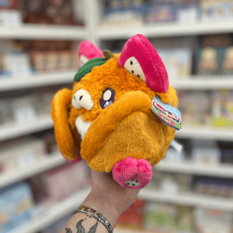 Mini Squishable Fruit Bat plush toy held in hand, side view