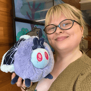 Mini Squishable Haunted Moth plush being held to show its size