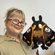 Mini Squishable Hawkmothman plush being held
