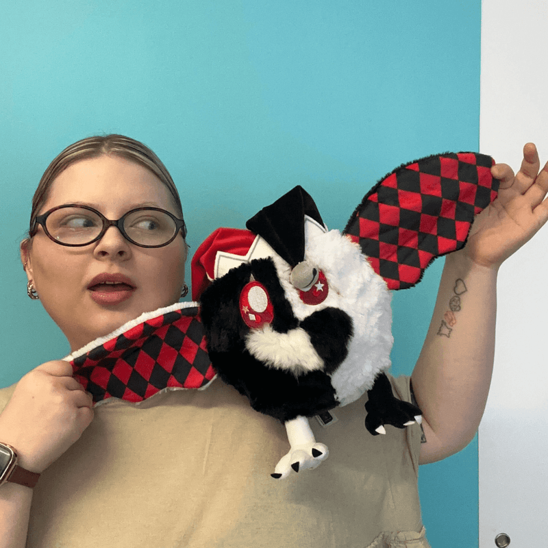 Mini Squishable Jester Mothman plush being held with wings spread