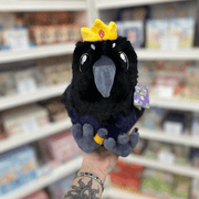 Mini Squishable King Raven plush toy held in hand, front view