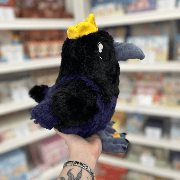 Mini Squishable King Raven plush toy held in hand, side view