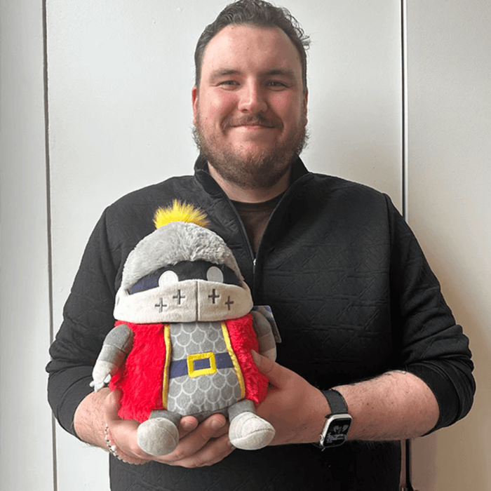 Person holding Mini Squishable Knight plush toy showing the front and helmet details