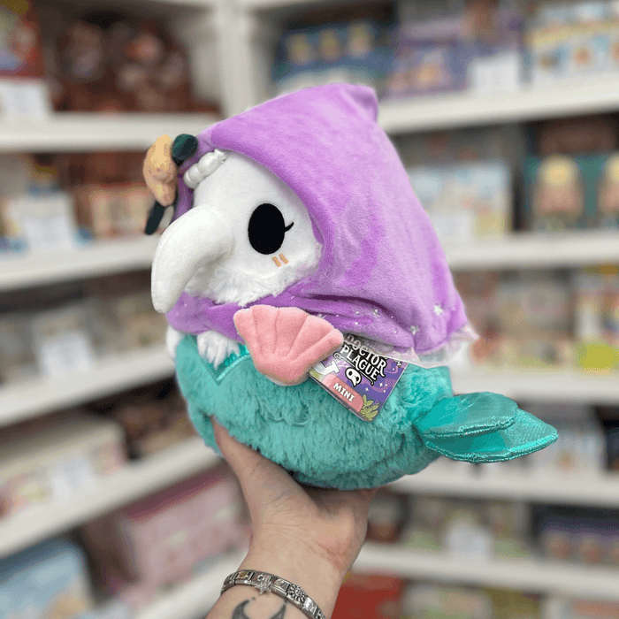 Mini Squishable Mermaid Plague Nurse plush toy held in hand with tag visible
