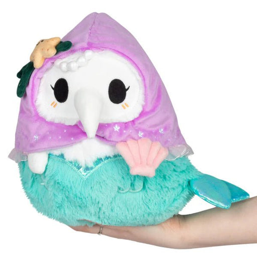 Mini Squishable Mermaid Plague Nurse plush with purple hood, teal tail, and shell detail.