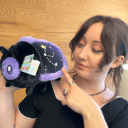 Mini Squishable Midnight Moth plush being held to show its size