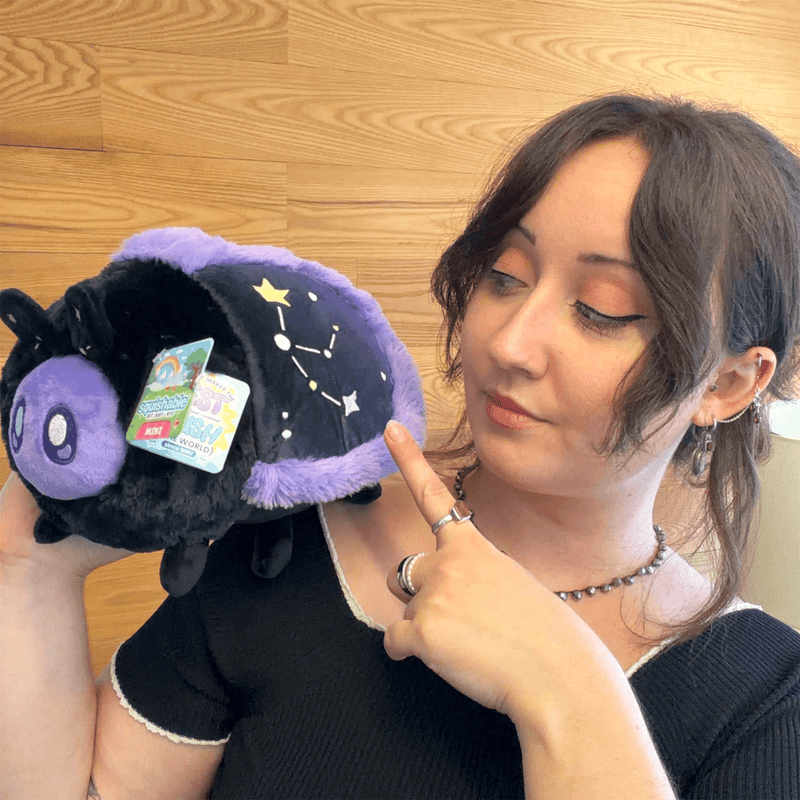 Mini Squishable Midnight Moth plush being held to show its size