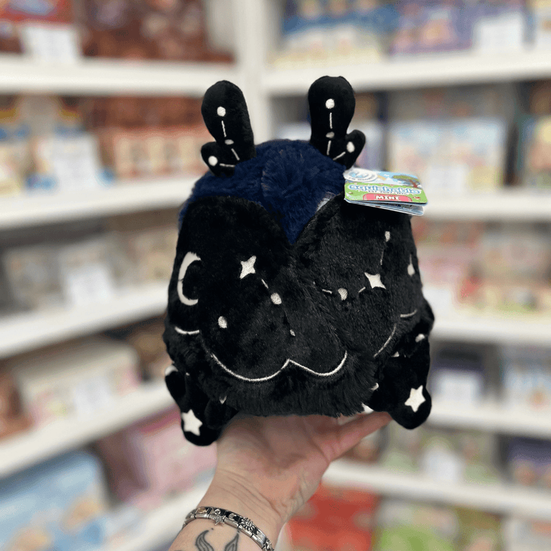 Mini Squishable Midnight Mothman plush toy held in hand with wings closed