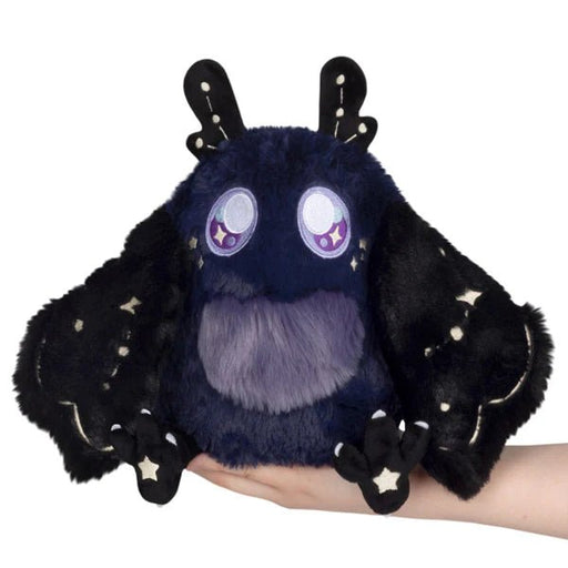 Mini Squishable Midnight Mothman plush with starry wings and purple belly, held in hand