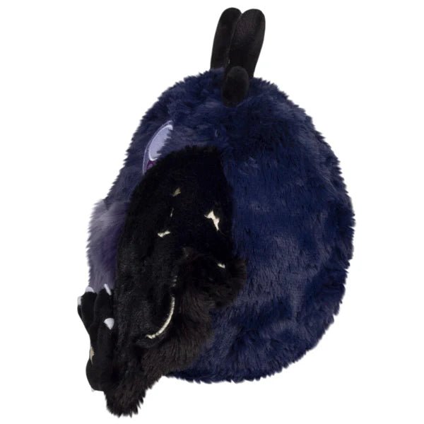 Side view of Mini Squishable Midnight Mothman plush showing starry wing and rounded body