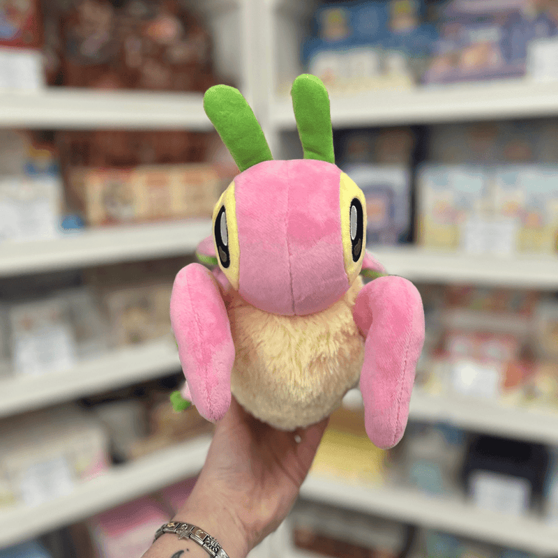 Mini Squishable Orchid Mantis plush toy held in hand, front view showing the pink body, pale fluffy underside, large embroidered eyes and green antennae