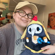 Person holding Mini Squishable Pharaoh Plague Doctor plush with golden Egyptian headdress and blue ceremonial staff