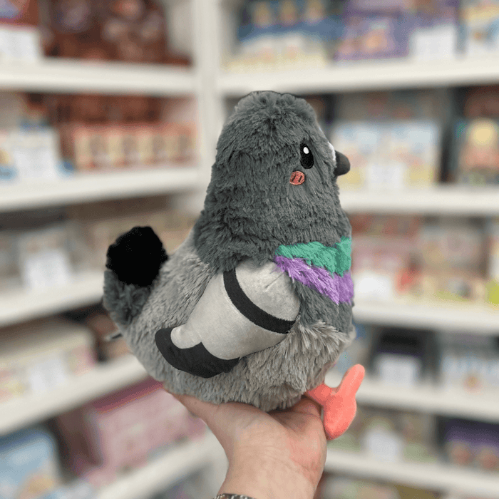 Mini Squishable Pigeon plush toy held in hand, side view