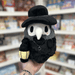 Mini Squishable Plague Doctor plush toy held in hand, front view