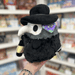 Mini Squishable Plague Doctor plush toy held in hand with tag visible