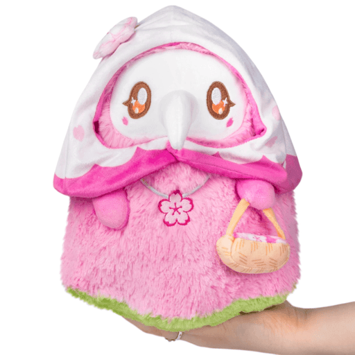 Front view of Mini Squishable Sakura Plague Nurse Plush with blossom hood, beak mask and tiny basket