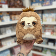 Mini Squishable Sleepy Sloth plush toy held in hand, front view showing the soft tan fur, cream face, sleepy embroidered eyes and cuddly seated shape