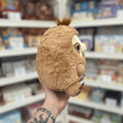 Mini Squishable Sleepy Sloth plush toy held in hand, side and back view showing the soft plush texture, rounded shape and tuft of fur on top