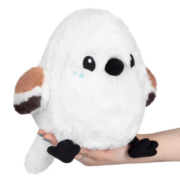 Mini Squishable Snow Fairy Bird plush toy, white fluffy bird with brown wings, black feet and blue snowflake cheeks.