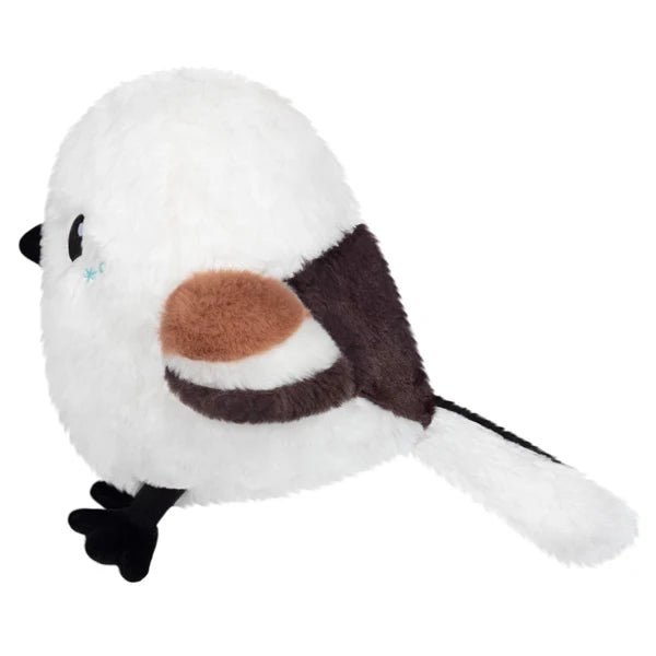 Side view of Mini Squishable Snow Fairy Bird plush toy with brown wing and fluffy white tail.