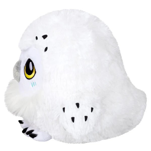 Side view of Mini Squishable Snowy Owl plush toy with fluffy wings and black speckle accents.