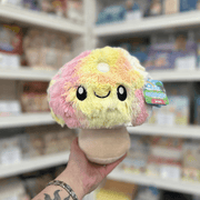 Mini Squishable Tie Dye Mushroom plush toy front view held in hand in a shop