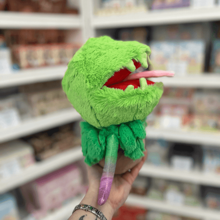 Mini Squishable Venus Flytrap plush toy held in hand, side view